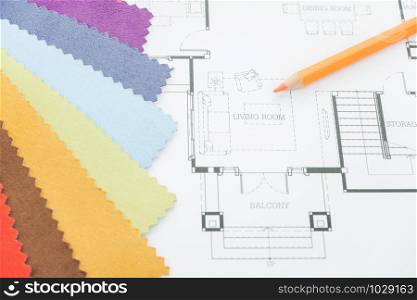 Architectural drawing with sample of material on working desk