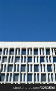Architectural grid work with blue sky background.