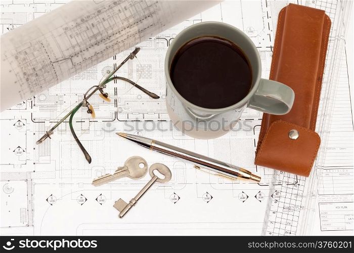 Architectural plan with key and coffee