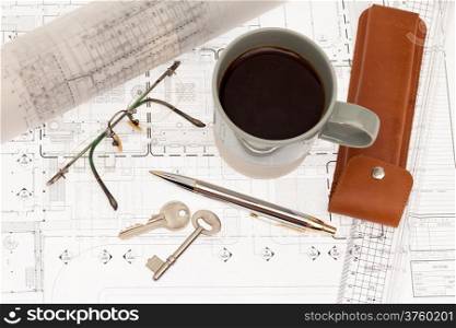 Architectural plan with key and coffee