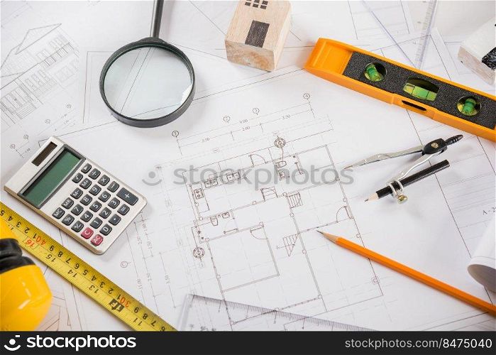 Architectural project workplace. Top view of house plan blueprint paper with repair tools on table desk at architecture office, Engineering architect design tools concept