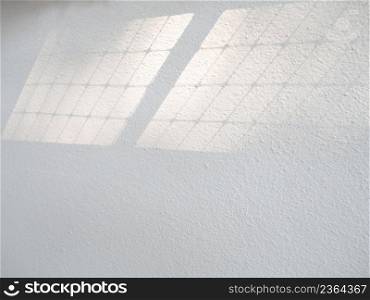 Architecture abstract background with light shadow overlay from window on gray texture wall.