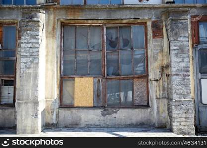 architecture and construction concept - old industrial building with broken glass window. old industrial building with broken glass window