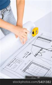architecture and home renovation concept - architect drawing on blueprint using flexible ruler