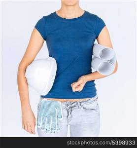 architecture and home renovation concept - woman architect with helmet and blueprint