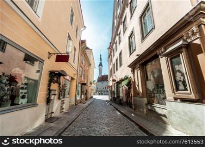 architecture and urban concept - empty street of Tallinn city old town leading to hall square. Tallinn old city street going to town hall square