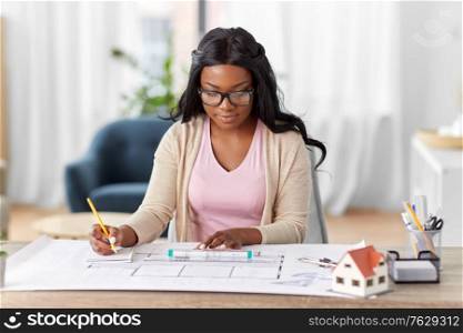 architecture, building, construction and real estate concept - african american female architect with blueprint, ruler and notebook working at home office. female architect with house model and blueprint