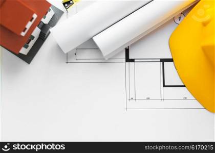 architecture, building, construction, real estate and home concept - close up of architectural blueprint and tools