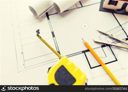 architecture, building, construction, real estate and home concept - close up of house blueprint and tools. close up of architectural blueprint and tools
