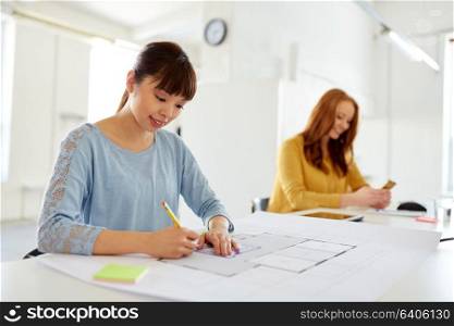 architecture, business and people concept - female architect with blueprint working at office. female architect with blueprint working at office