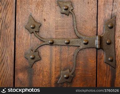 Architecture. Closeup of wooden door with rivets as background or backdrop. Architectural detail.