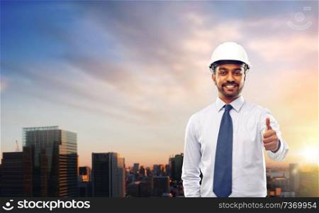 architecture, construction business and building - smiling indian architect or businessman in helmet showing thumbs up over grey background. architect or businessman in helmet shows thumbs up