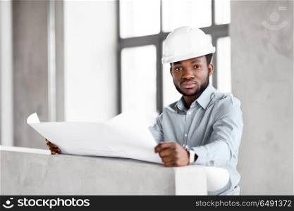 architecture, construction business and people concept - african american architect in helmet with blueprint. african architect in helmet with blueprint. african architect in helmet with blueprint