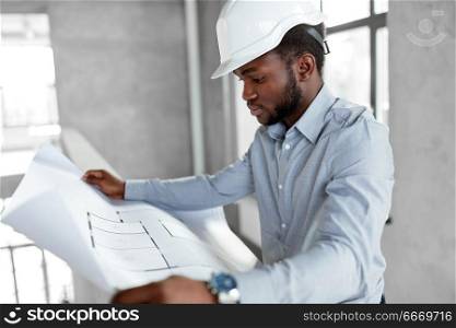 architecture, construction business and people concept - african american architect in helmet with blueprint. african architect in helmet with blueprint. african architect in helmet with blueprint