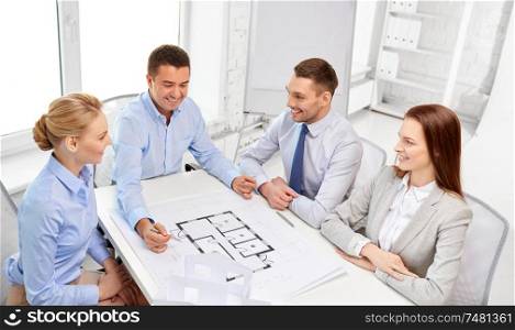 architecture, construction business and people concept - happy team of architects discussing blueprint at office. happy business team discussing blueprint at office