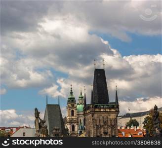 Architecture details, houses, church, tower and sculpture. A view from the Charles Bridge in Prague