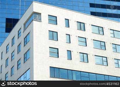 architecture, exterior, business and construction concept - close up of multistory office building in city