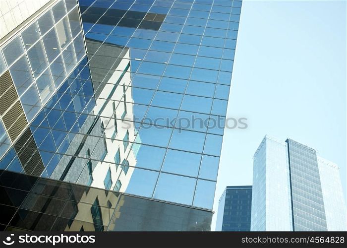 architecture, exterior, business, real estate and construction concept - close up of office building or skyscraper and sky