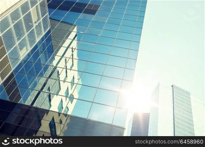 architecture, exterior, business, real estate and construction concept - close up of office building or skyscraper and sky. close up of office building or skyscraper and sky
