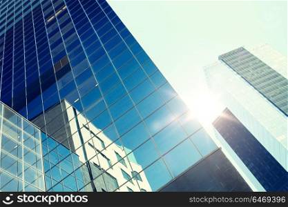 architecture, exterior, business, real estate and construction concept - close up of office building or skyscraper and sky. close up of office building or skyscraper and sky