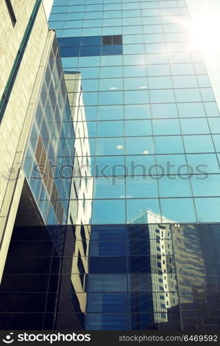 architecture, exterior, business, real estate and construction concept - close up of office building or skyscraper and sky. close up of office building or skyscraper and sky