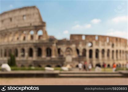 architecture, history and tourism concept - Colosseum in Rome blurred background