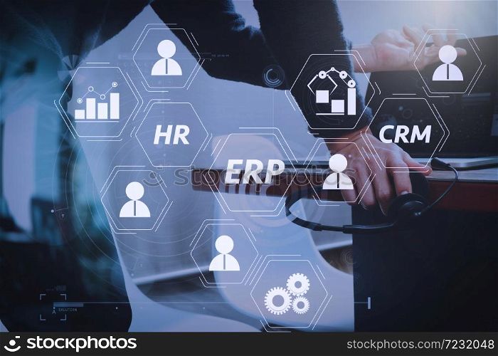 Architecture of ERP (Enterprise Resource Planning) system with connections between business intelligence (BI), production, CRM modules and HR diagram.Man using VOIP headset with digital tablet computer.