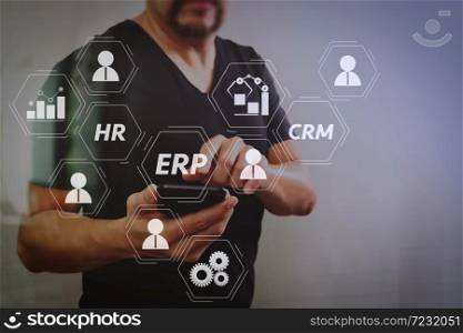 Architecture of ERP (Enterprise Resource Planning) system with connections between business intelligence (BI), production, CRM modules and HR diagram.Designer hand using smart phone for mobile payments online.