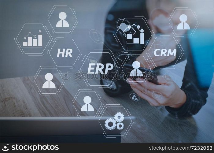 Architecture of ERP (Enterprise Resource Planning) system with connections between business intelligence (BI), production, CRM modules and HR diagram.Businessman hand using mobile payments online shopping.
