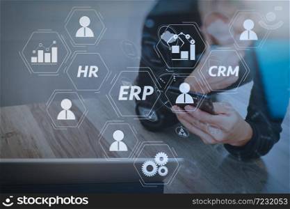 Architecture of ERP (Enterprise Resource Planning) system with connections between business intelligence (BI), production, CRM modules and HR diagram.Businessman hand using mobile payments online shopping.