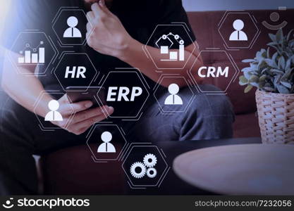 Architecture of ERP (Enterprise Resource Planning) system with connections between business intelligence (BI), production, CRM modules and HR diagram.designer man hand using smart phon for mobile payments online.