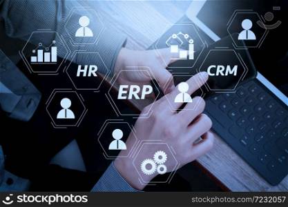 Architecture of ERP (Enterprise Resource Planning) system with connections between business intelligence (BI), production, CRM modules and HR diagram. businessman hand using smart phone,mobile payments online shopping.