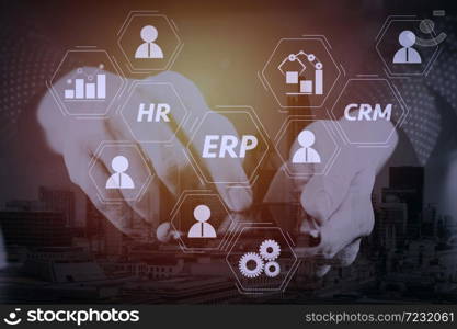 Architecture of ERP (Enterprise Resource Planning) system with connections between business intelligence (BI), production, CRM modules and HR diagram.businessman hand working with mobile phone.