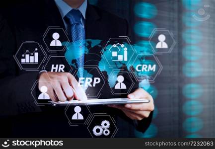 Architecture of ERP (Enterprise Resource Planning) system with connections between business intelligence (BI), production, CRM modules and HR diagram.businessman working with new modern computer.