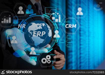 Architecture of ERP (Enterprise Resource Planning) system with connections between business intelligence (BI), production, CRM modules and HR diagram.businessman hand holding cloud network icon on touch screen computer.