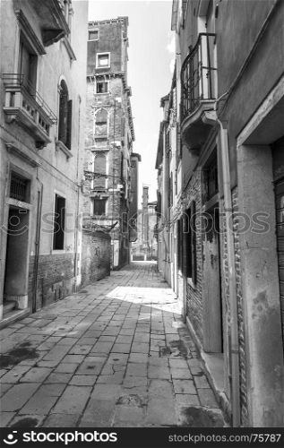 Architecture of medieval Venice. Houses peeling off from dampness. Black and white picture