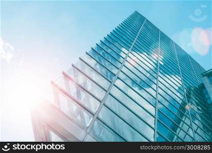 Architecture of modern skyscraper in business district with sun light. Smart city business background concept or use for website background.