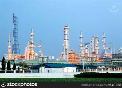 Architecture of Oil Refinery Plant with distillation tower with Sunset Twilight