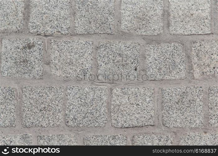 architecture, stonework and tiled masonry concept - close up of paving stone or facade tile texture