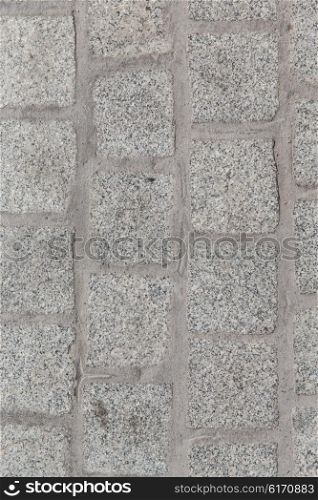 architecture, stonework and tiled masonry concept - close up of paving stone or facade tile texture