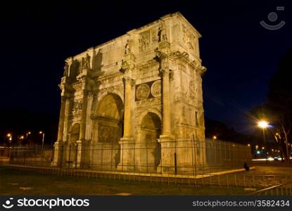 Arco Costantino. famous triumphal arch standing next to the colosseum in Rome at night
