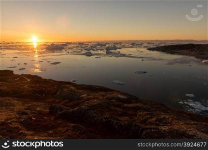 Arctic landscape in Greenland. Arctic landscape in Greenland around Ilulissat with icebergs and sunset