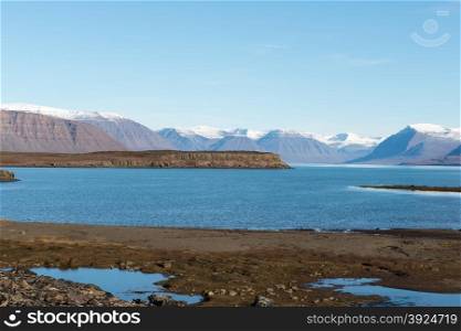 Arctic landscape in Greenland. Arctic landscape in Greenland in late summer and early autumn with snowy mountains and ocean