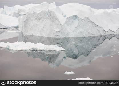 Arctic landscape in Greenland around Disko Island with icebergs, ocean, and cloudscape