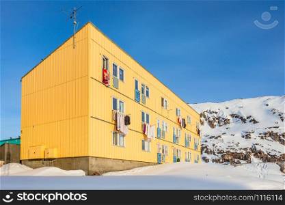 Arctic living residential house with snow hill in the background, Ilulissat city, Greenland