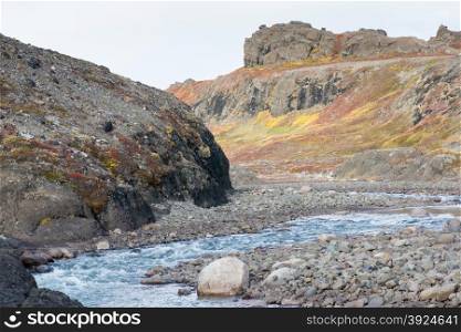 Arctic river in summer. A river in the arctic during summer and autumn with colorful vegetation