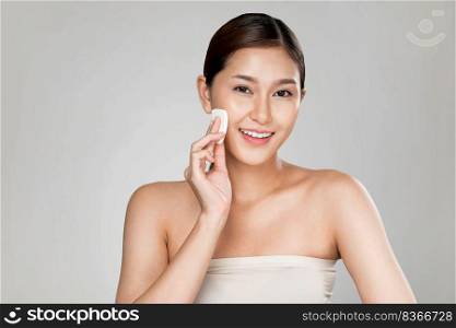 Ardent woman applying her cheek with dry powder and looking at camera. Portrait of younger with perfect makeup and healthy skin concept.. Ardent woman applying her cheek with dry powder while looking at camera.