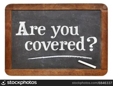 Are you covered question - white chalk text on a vintage slate blackboard, insurance concept