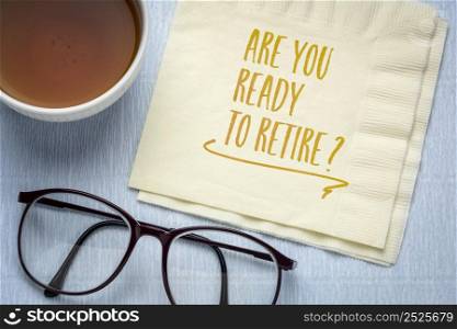 Are you ready to retire? Handwriting on a napkin with a cup of coffee and glasses. Finance and retirement planning concept.