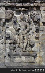 Arfuna on the wall of temple in Plateau Dieng, Java